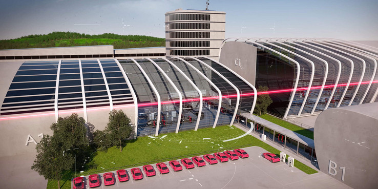 Large building with several red cars in the parking lot