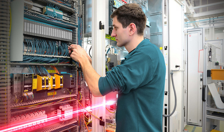 Person wiring a control panel